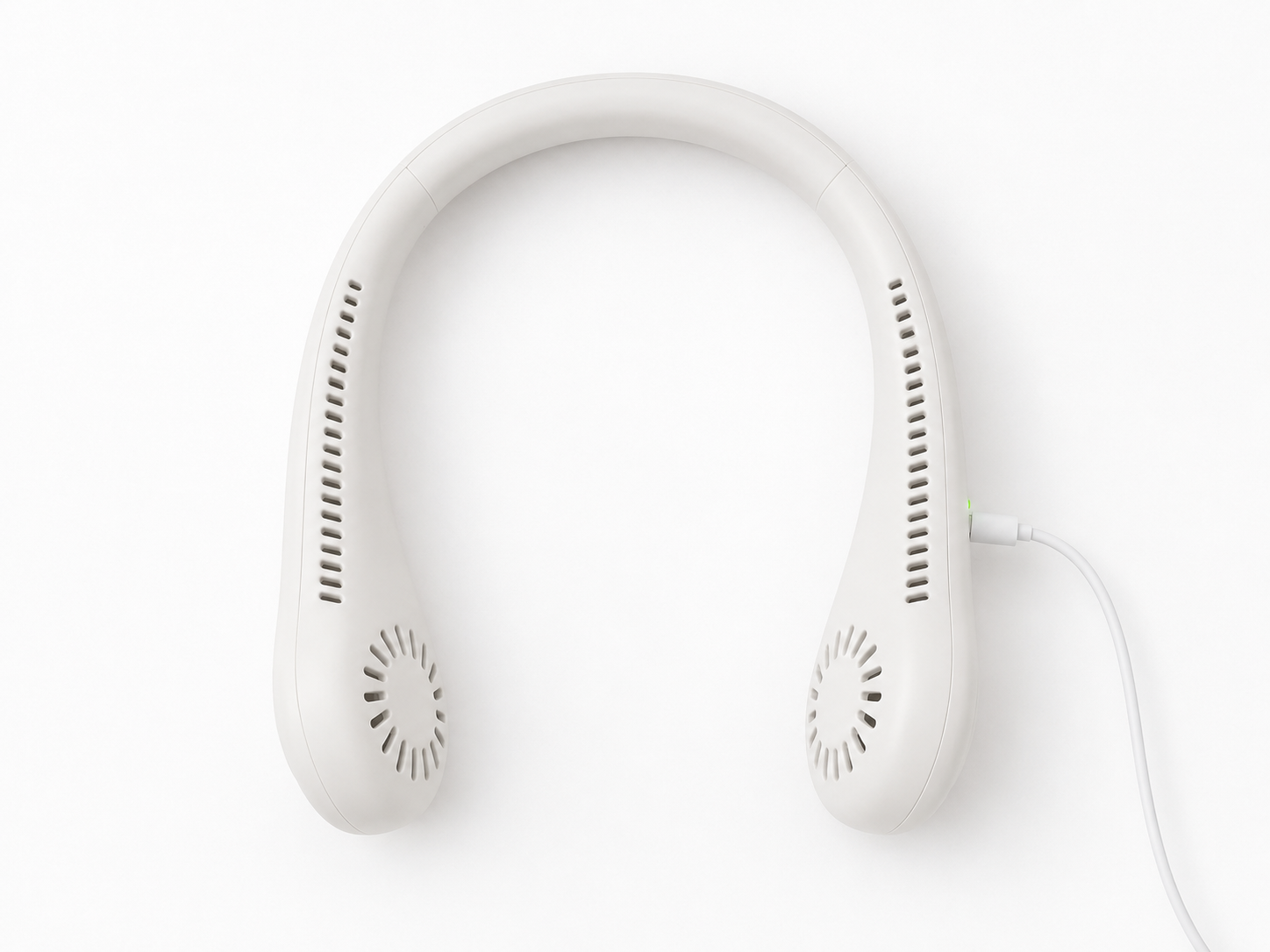 BreezeLoop neck fan lying flat on white surface with USB-C cable plugged into side port and green LED charging indicator visible
